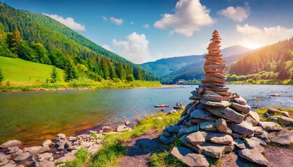 picturesque summer view of stone pyramid is laid out by tourists on the shore of zhenets river splendid outdoor scene of carpathian mountains ukraine europe beauty of nature concept background - obrazy, fototapety, plakaty
