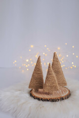 Christmas tree made of straw on a white background with bokeh.