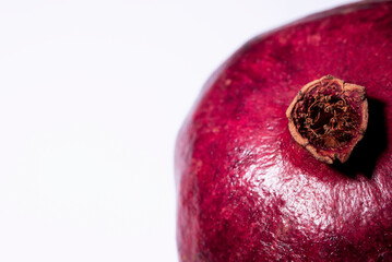 An organic pomegranate on a white background, macro photography, isolated