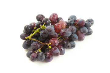 Bunch of organic black grapes isolated on white background.