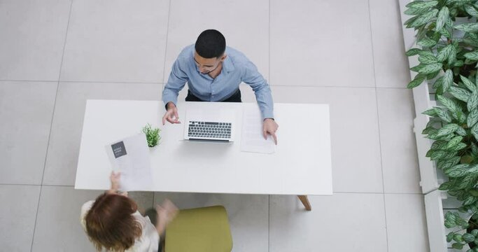 Business people, handshake and meeting above for interview, teamwork or hiring at workplace. Top view of employees shaking hands by table in recruiting for b2b, agreement or partnership at office