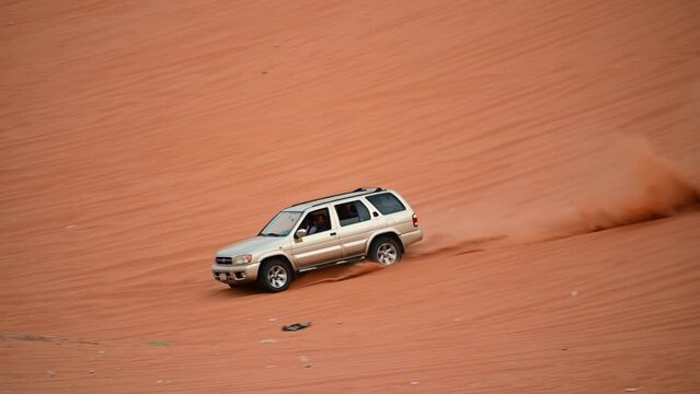 Riyadh, Saudi Arabia &ndash; November 1st 2023: Offroad vehicles bashing and climbing desert safari dunes ,red sand dunes adventurous ride 4x4 vehicle in Riyadh. Modified car, customized vehicle