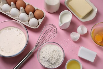 Composition with whisk and dough in bowl on pink background, flat lay