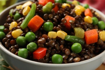 Delicious lentils with vegetables in bowl, closeup