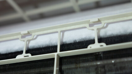 close-up of Frozen or Ice in air conditioning. Problems with home cooling systems caused by leaks...
