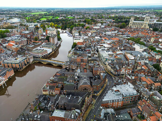 Top cinematic aerial view to the cozy city York, United Kingdom. Red roofs and beautiful streets...