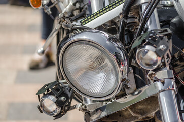chrome shiny chopper motorcycle headlight close up