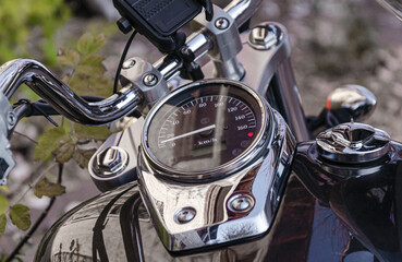 handlebar and speedometer of classic chopper motorcycle close up