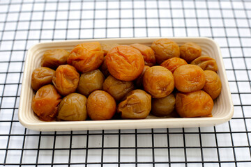Pickled plums in white plate