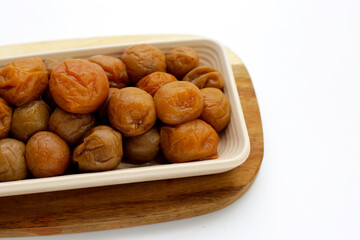 Pickled plums on white background.
