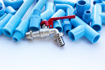 Faucet with blue pvc pipe connections for plumbing work. Plumber equipment