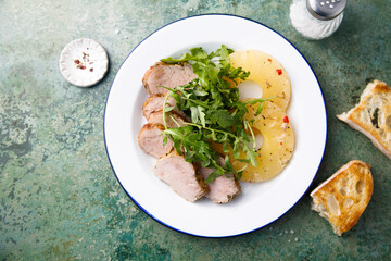 Roasted pork with pineapple and arugula