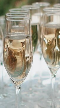 A glass of champagne stands on the festive table at the wedding of the bride and groom