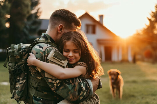 emotional meeting of soldier and daughter in front of the house while coming home from duty. hug each other