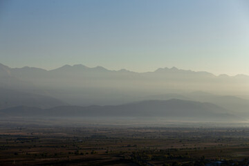 valley in the mountains at dawn in the fog