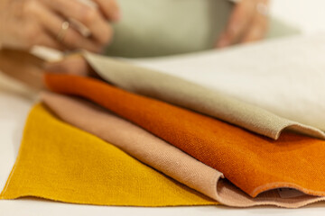 stack of textile fabric material in different colors 