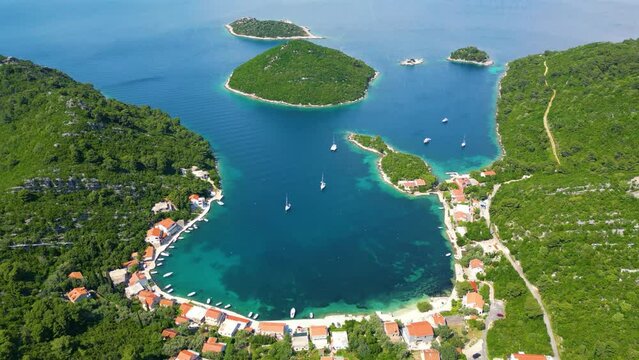 A bay in Mljet Island, Croatia. Tourist destination in the Adriatic sea. Beautiful place for summer holidays and vacations. Boats and yachts docked in the bay.
