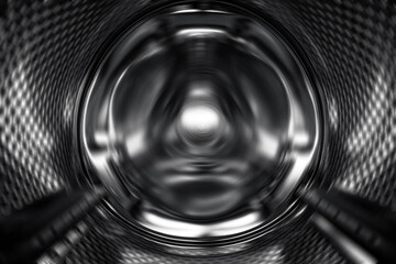 Washing Dryer Machine inside view during work. Drum of the washing machine rotates, view from the inside. Metal drum of a washing machine. Abstract home background. Inside of washing machine - obrazy, fototapety, plakaty