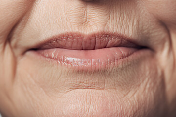 Close up of elderly woman's wrinkles around mouth - obrazy, fototapety, plakaty