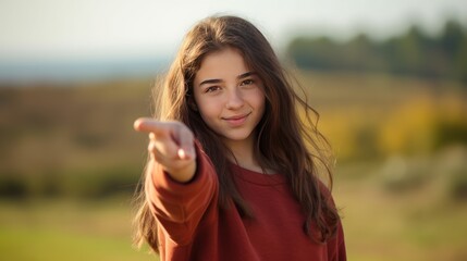 Teen girl, pointing with index fingers to a copy space. teenagers and nature