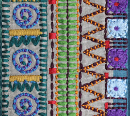 An ethnic embroidered fabric pattern closeup