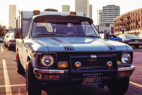 Los Angeles, California, USA - May 15, 1984:  Archival photo of 1978 blue Chevy Luv pickup truck with camper shell and fog lights.  Shot on slide film near 2nd and Alameda in downtown LA.