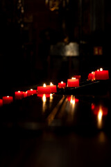 Votive candles burning peacefully in the church. Votive thanks in the Christian religion. Photo...