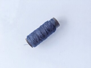 Roll of thread on white background