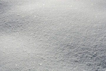 Glittering snow surface in sunlight with sparkling ice crystals
