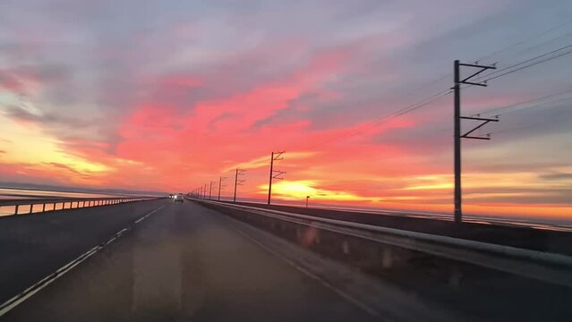 Colorful sunset taken from the window of a moving car.