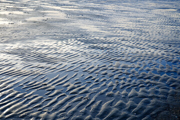 Close up of tide ripples on a sand beach 
