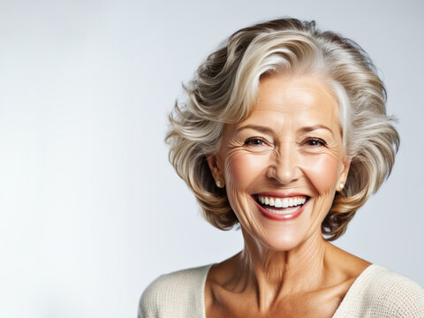 Beautiful gorgeous 60s elderly  model woman with grey hair laughing and smiling. Mature old lady close up portrait. Isolated on plane  background. Healthy face skin care beauty, 