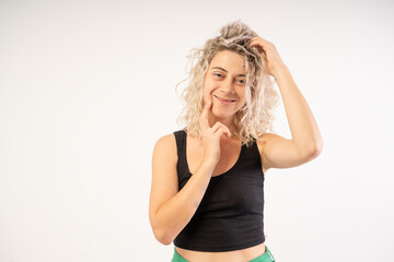 Portrait of a happy young woman isolated on a white background with a tiara on her head wearing a dress