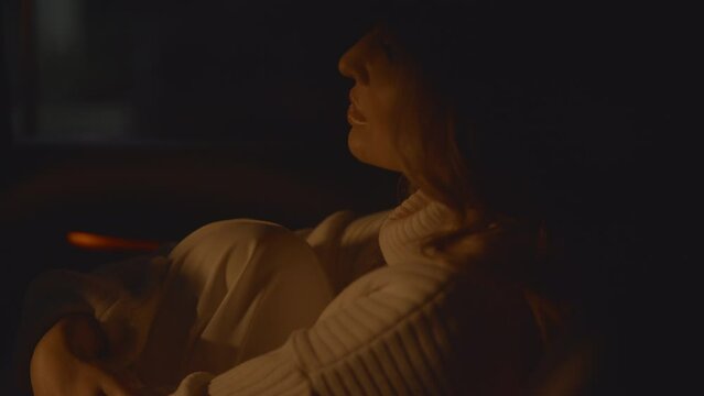 Close up of a sensual woman in the car, feeling cold and uncomfortable under thunderstorm and lightning outside, night scene. Being vulnerable, dreaming and waiting. High Quality 4k footage
