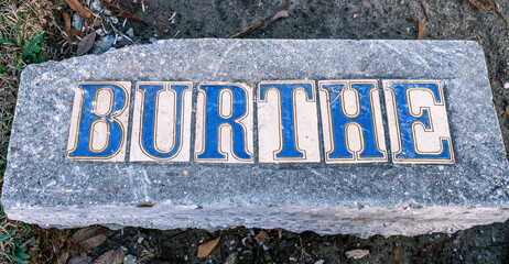 Burthe Street Sidewalk Sign Tile Inlay Which has Removed from the Original Sidewalk for Repositioning in a Renovated Sidewalk in New Orleans, Louisiana, USA