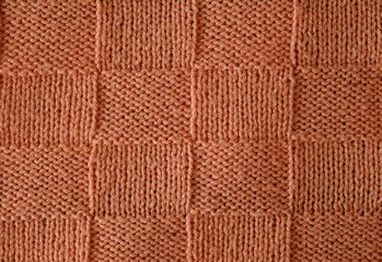 Unusual abstract knitted chess pattern background texture. Top view, close-up. Handmade knitting wool 