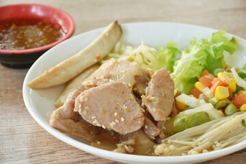 Korean fried slice pork with salad on plate dipping spicy sauce