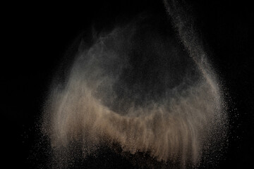 Soil explosion on black background. Abstract texture. Cloud of brown ground. Sand explode.	
