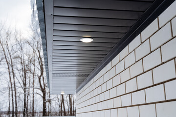 Street lighting, spot lighting on the roof of the house, country house, roof gable.