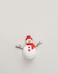 snowman with a red hat and scarf on a snow  - obrazy, fototapety, plakaty