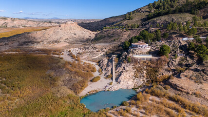 Aerial drone view of the lake Negratin in Spain with the hot springs.