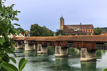 The Rhine with the historic wood bridge and Fridolins munster in Bad Saeckingen in summer, Germany