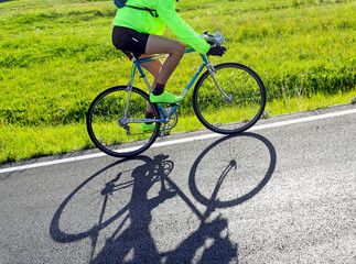 cyclist with racing bicycle and phosphorescent waterproof jacket