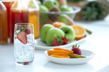 Glass with ice and fruit slices is prepared for the kombucha drink, homemade kombucha beverage from tea mushroom, organic probiotic healthy drink