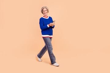 Photo of lovely cheerful woman addicted user walking reading telegram instagram empty space...