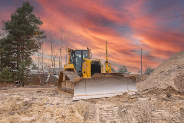 Crawler dozer against the background of a beautiful sunrise. Construction equipment. Bulldozer at...