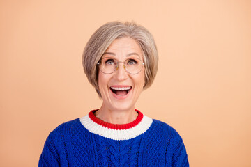 Photo of ecstatic woman with gray hair dressed knitwear sweater in glasses look at offer empty...