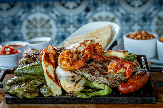 Parrillada de Sonora -Northern-style mixed grill with carne asada steak, mesquite chicken breast, chorizo links, spicy shrimp, Asadero cheese, cactus
paddles, grilled onions, and chile toreado