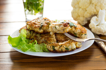 cooked vegetarian fried cauliflower cutlets in a plate