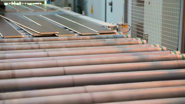 Factory for the production of hardwood flooring and laminate flooring. Conveyor with parquet board.  Warehouse of finished laminate flooring.